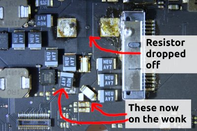 MacBook Air logic board after, with resistors dropped off and components wonky.