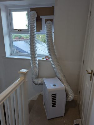 Completed dual-hose conversion with both intake and exhaust ducts out the window (ElectriQ AC9000E / Rob / 2026 / 06)