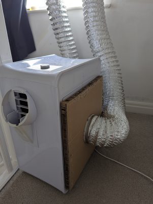 Side view of the cardboard ducting with standoff keeping it clear of the intake grille (ElectriQ AC9000E / Rob / 2026 / 06)