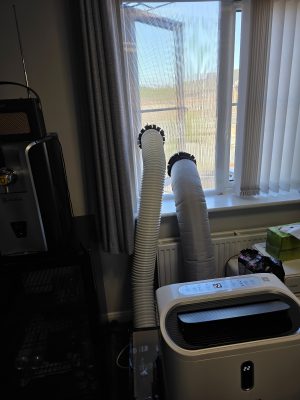 Completed conversion, front view with hoses out of window (MeacoCool MC12000CHR Pro / Ian / 2026 / 07)